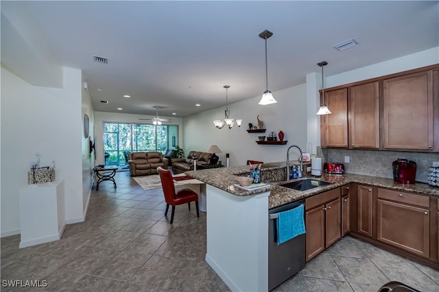 kitchen with kitchen peninsula, backsplash, dishwasher, decorative light fixtures, and sink