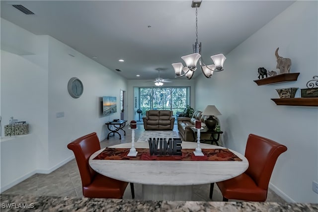 tiled dining room with ceiling fan with notable chandelier