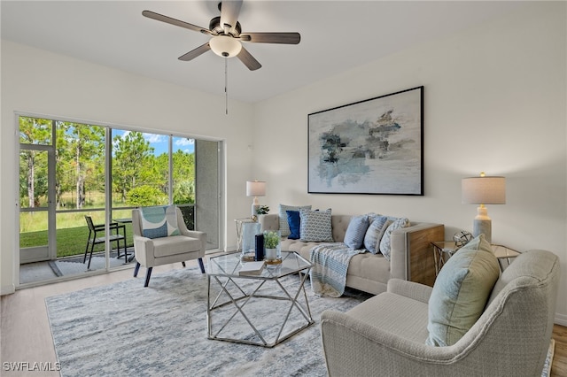 living room with ceiling fan and hardwood / wood-style floors