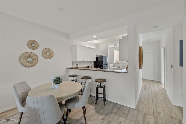 dining space with light wood-type flooring