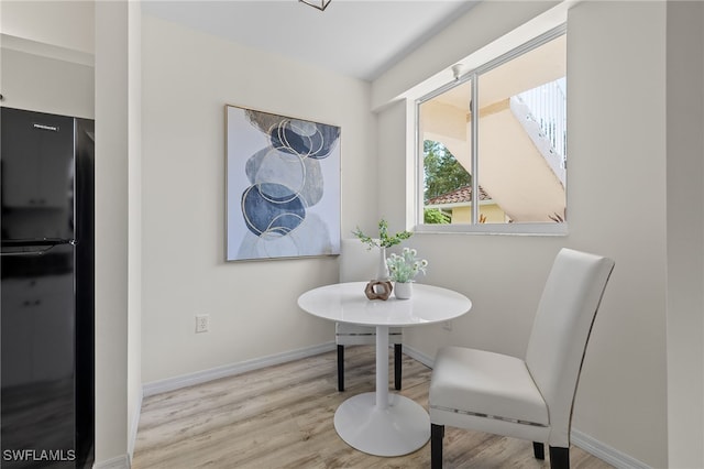 dining space featuring breakfast area and light hardwood / wood-style flooring