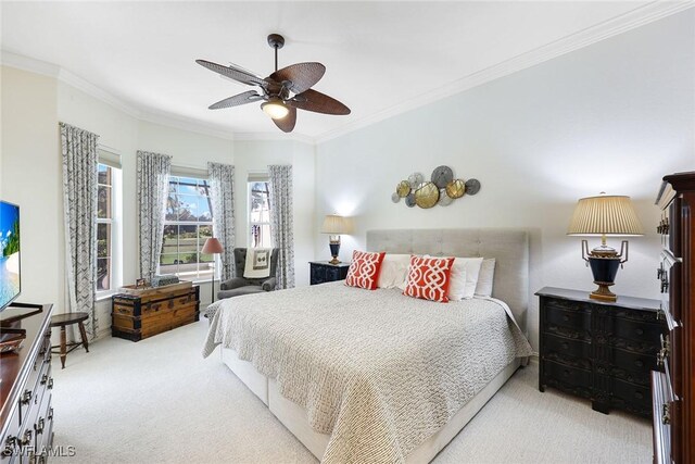 carpeted bedroom featuring ceiling fan and crown molding