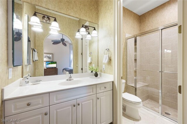 full bath featuring ensuite bathroom, a stall shower, toilet, and wallpapered walls