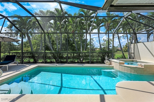 view of swimming pool with a lanai, a pool with connected hot tub, and a patio