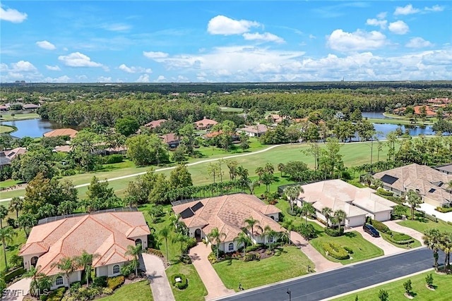 drone / aerial view with a water view and a residential view