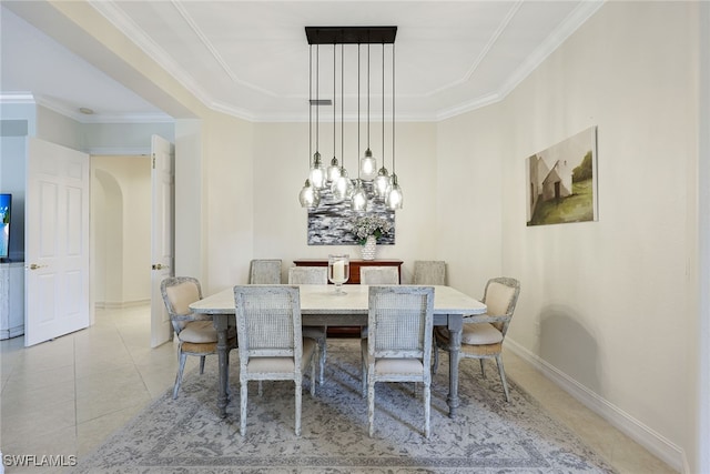 dining space featuring light tile patterned flooring, crown molding, and baseboards