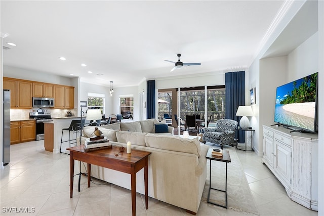 living room with light tile patterned floors, ceiling fan, crown molding, and recessed lighting