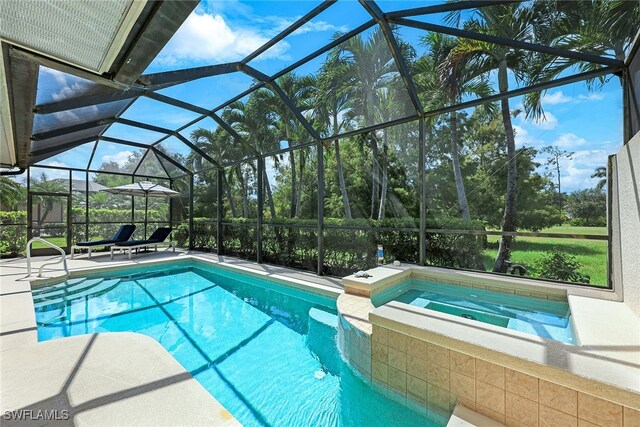 view of swimming pool featuring a lanai, a patio area, and a pool with connected hot tub