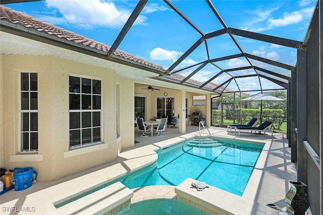 outdoor pool with a lanai, a patio area, ceiling fan, and an in ground hot tub