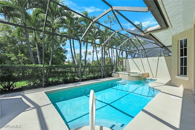 view of swimming pool with a lanai, a pool with connected hot tub, and a patio