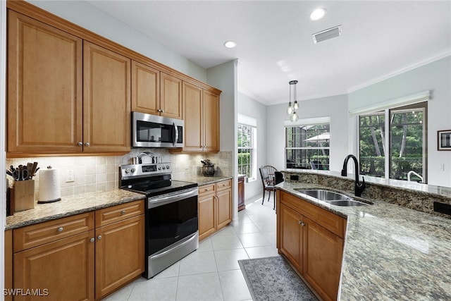 kitchen featuring light tile patterned flooring, a sink, visible vents, appliances with stainless steel finishes, and backsplash