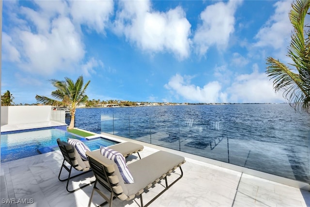 view of swimming pool with an in ground hot tub, a water view, and a patio