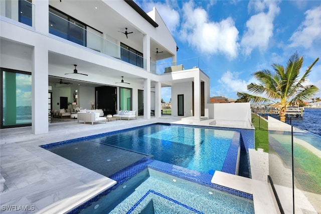 view of swimming pool with an in ground hot tub, an outdoor hangout area, ceiling fan, a water view, and a patio