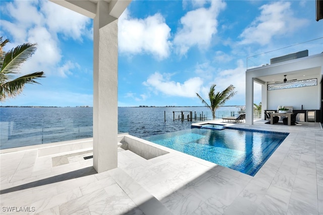 view of swimming pool with a patio area, an in ground hot tub, a water view, and ceiling fan