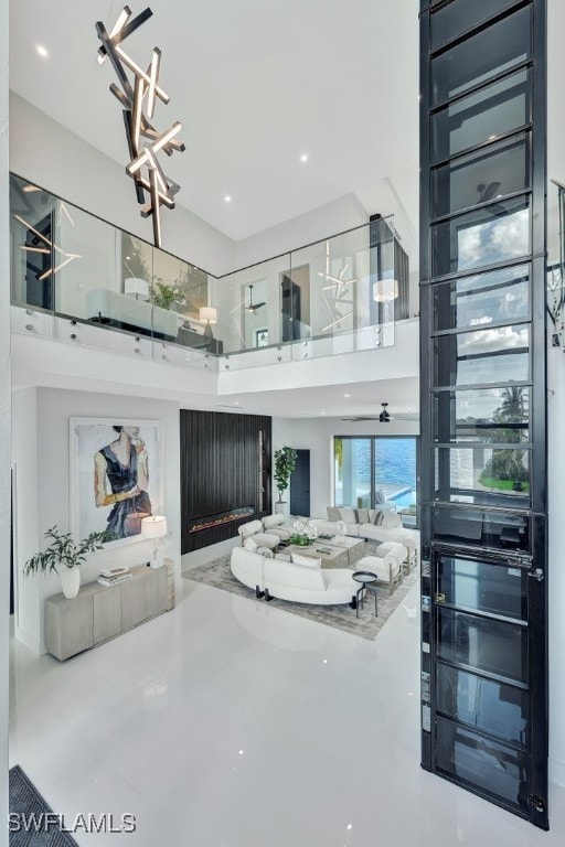 living room featuring a high ceiling and an inviting chandelier