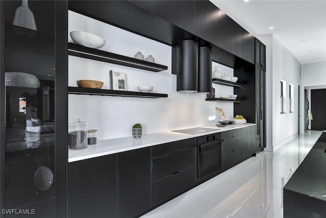 kitchen featuring range hood and black appliances