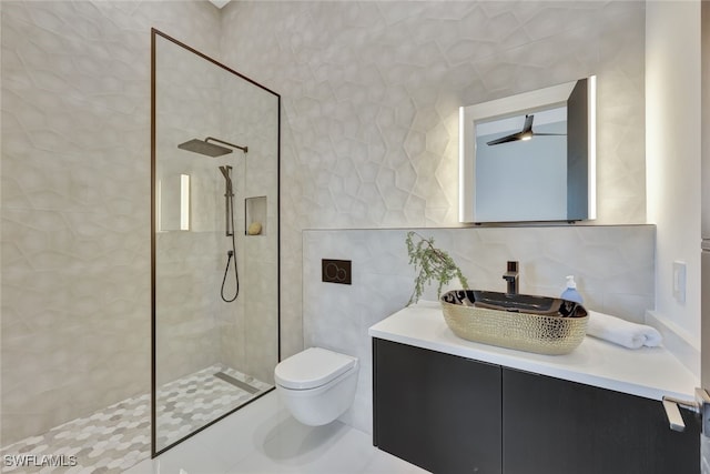 bathroom with decorative backsplash, a tile shower, vanity, tile walls, and toilet