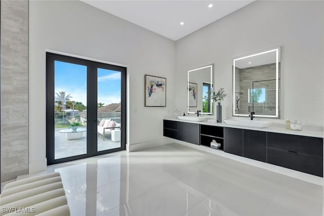 bathroom featuring tile patterned floors, french doors, vanity, and a shower with door