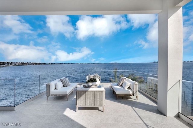 view of patio / terrace featuring outdoor lounge area, a water view, and a balcony