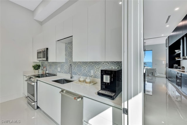 kitchen with sink, white cabinetry, and stainless steel appliances