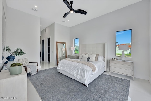 bedroom with a towering ceiling and ceiling fan