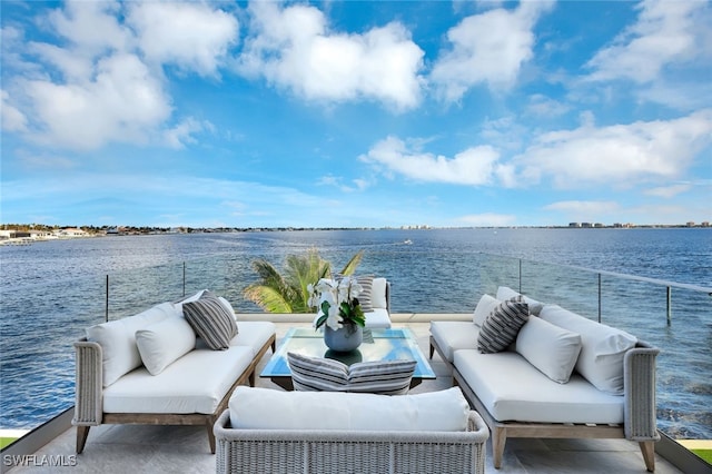 view of patio / terrace featuring a water view, an outdoor hangout area, and a balcony