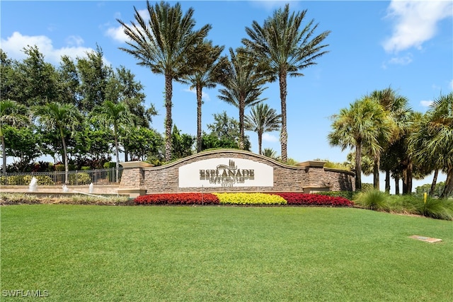 community sign featuring a lawn