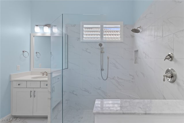 bathroom featuring vanity and tiled shower