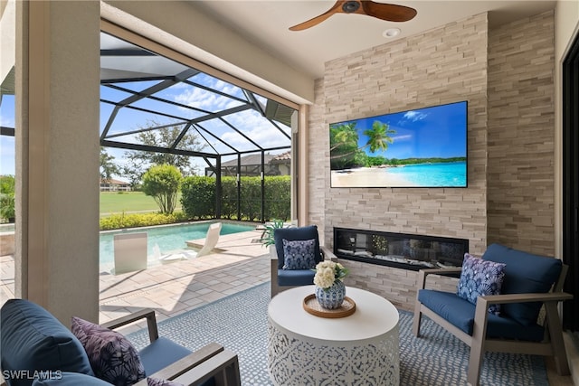 view of patio / terrace featuring glass enclosure, ceiling fan, and an outdoor hangout area