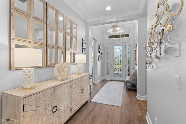 foyer with ornamental molding and dark wood-type flooring