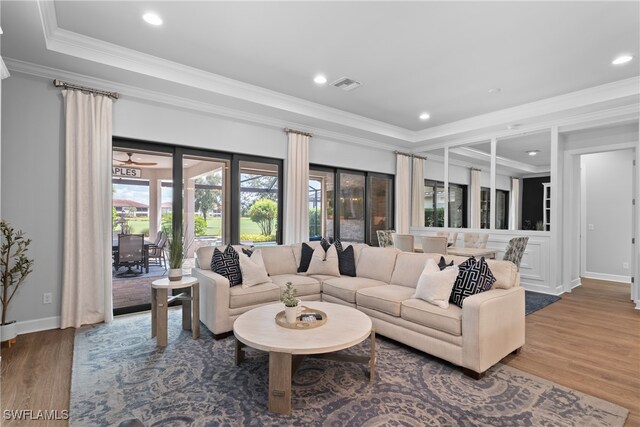 living room featuring hardwood / wood-style flooring and crown molding