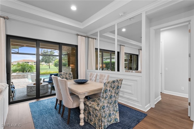 dining room featuring wood-type flooring and crown molding