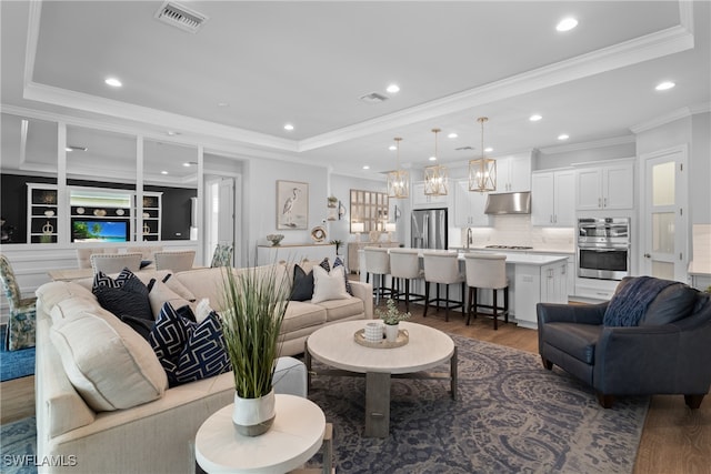 living room featuring dark hardwood / wood-style floors and ornamental molding