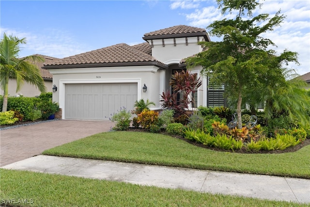 mediterranean / spanish-style house with a garage and a front lawn