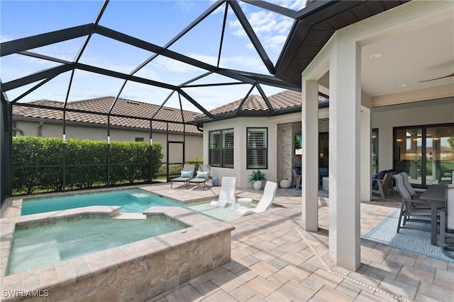 view of pool with an in ground hot tub, a lanai, and a patio area