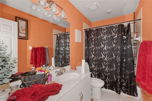 bathroom featuring a shower with curtain, vanity, toilet, and tile patterned floors