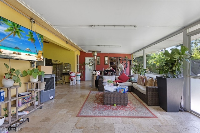 sunroom / solarium featuring track lighting