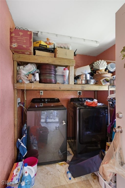 storage area featuring washing machine and clothes dryer