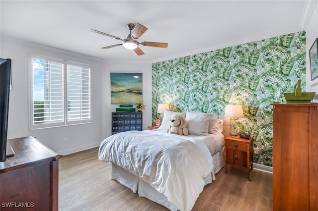 bedroom featuring ornamental molding, hardwood / wood-style floors, and ceiling fan