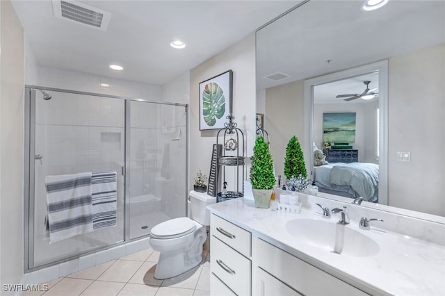 bathroom with ceiling fan, walk in shower, toilet, vanity, and tile patterned floors