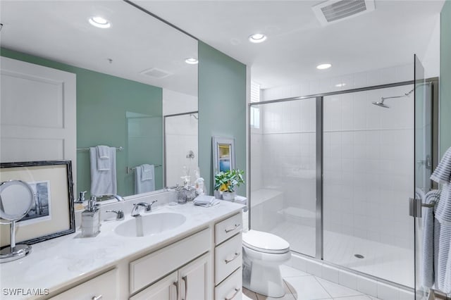 bathroom with vanity, tile patterned flooring, toilet, and an enclosed shower