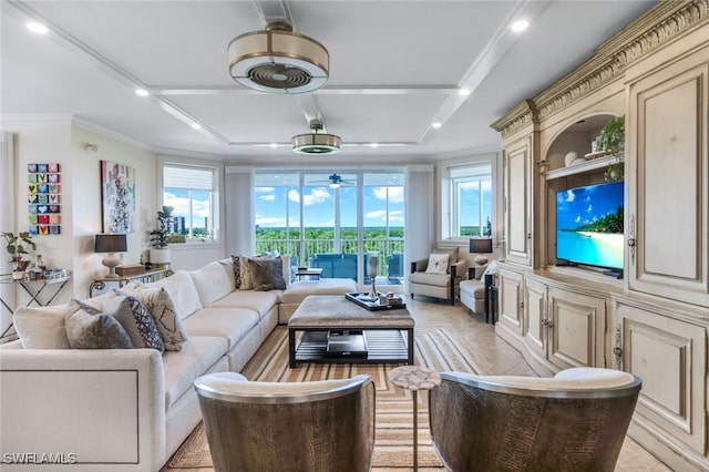 living room featuring ceiling fan, a healthy amount of sunlight, and ornamental molding