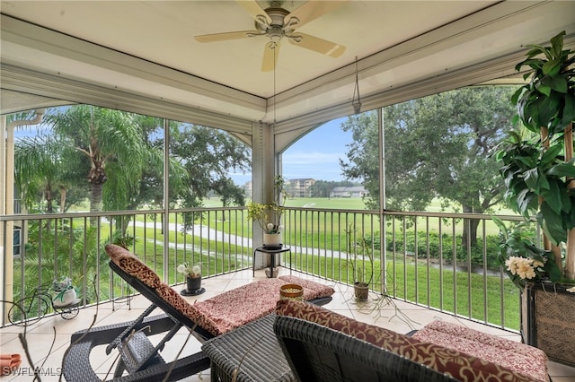 sunroom featuring a healthy amount of sunlight and ceiling fan