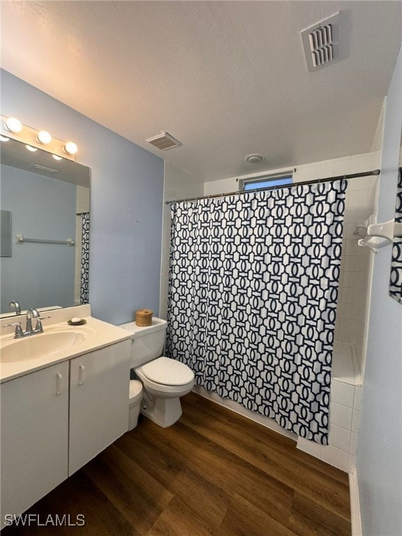 bathroom with vanity, hardwood / wood-style floors, and toilet