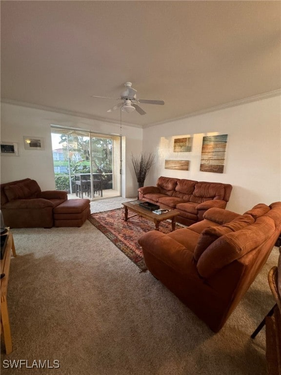 carpeted living room featuring ornamental molding and ceiling fan