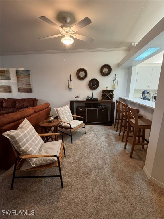 living room featuring crown molding, carpet flooring, and ceiling fan