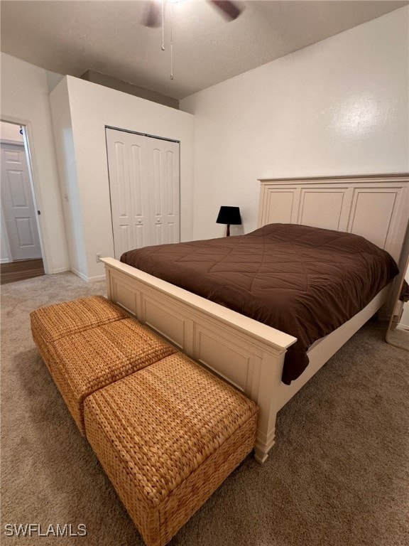 carpeted bedroom featuring ceiling fan and a closet