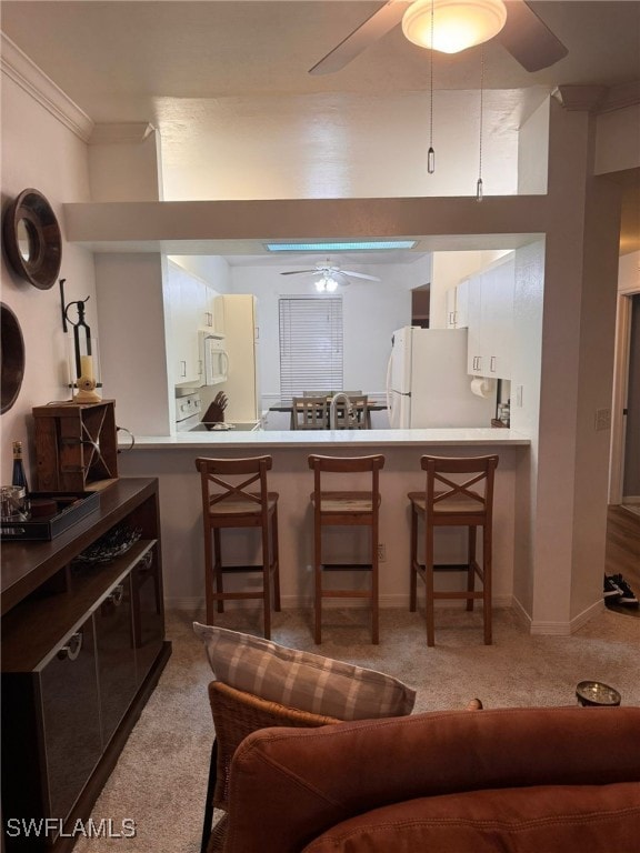 carpeted living room with ceiling fan and ornamental molding