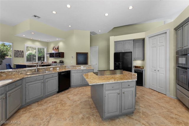 kitchen featuring gray cabinets, black appliances, a kitchen island, and sink