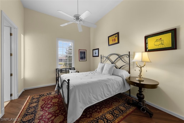 bedroom with dark hardwood / wood-style floors and ceiling fan